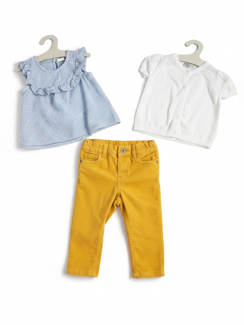 Elise Fay three-piece toddler outfit with a blue gingham ruffle top, white cardigan, and mustard yellow trousers.